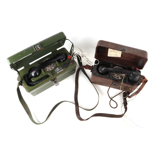 62 - Two military field telephones with spin dial, serial no: PO704B, 30cms wide.