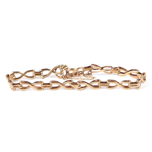 634 - A 9ct gold bracelet; together with a 9ct gold wishbone ring; a 9ct gold cross pendant; fine gold cha... 