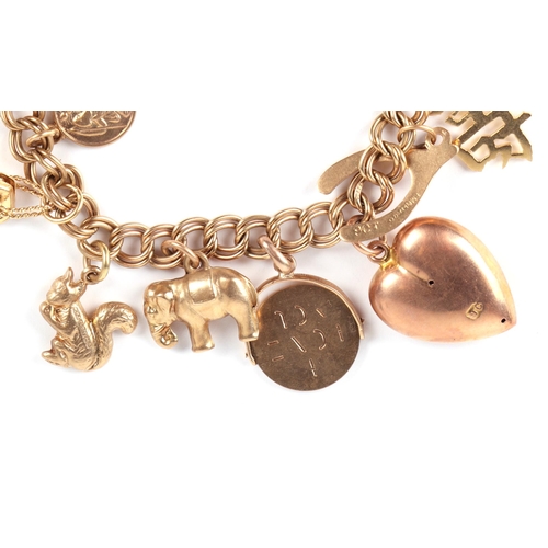 637 - A 9ct gold charm bracelet with twelve 9ct gold charms, two 14ct gold charms and two yellow metal cha... 