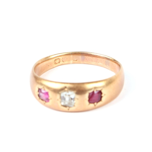 647 - A gold diamond and ruby three-stone gypsy ring, the central diamond 3mm by 4mm, indistinct Sheffield... 