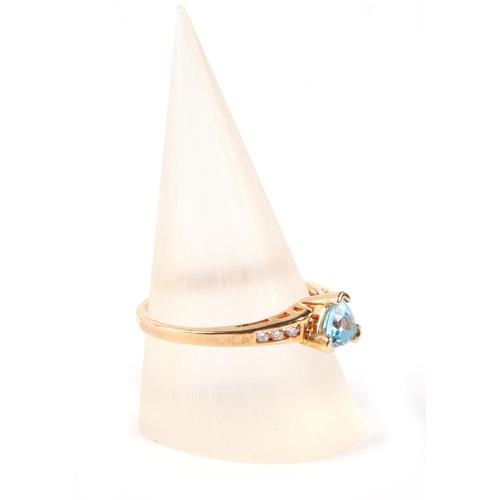 650 - A 14ct gold ring set with a triangular pale blue stone and diamond set shoulders, approx UK size P, ... 