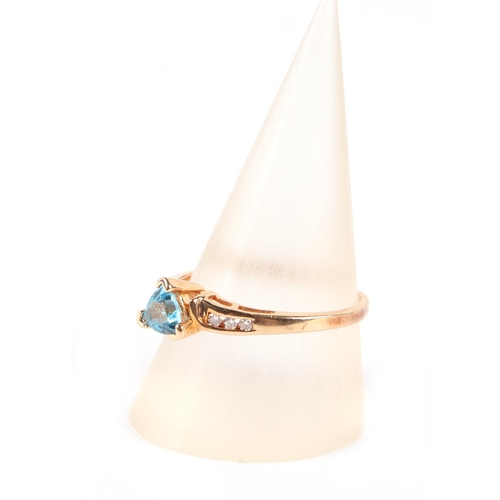 650 - A 14ct gold ring set with a triangular pale blue stone and diamond set shoulders, approx UK size P, ... 