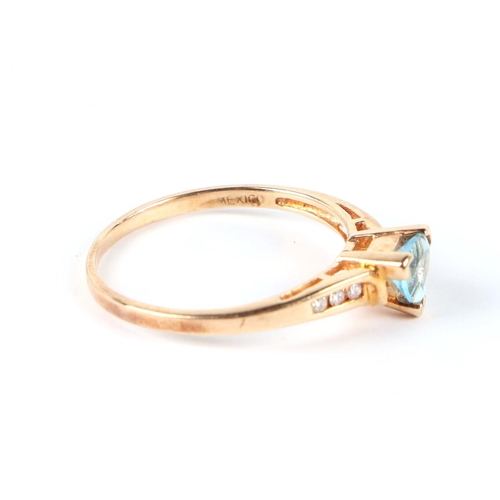 650 - A 14ct gold ring set with a triangular pale blue stone and diamond set shoulders, approx UK size P, ... 