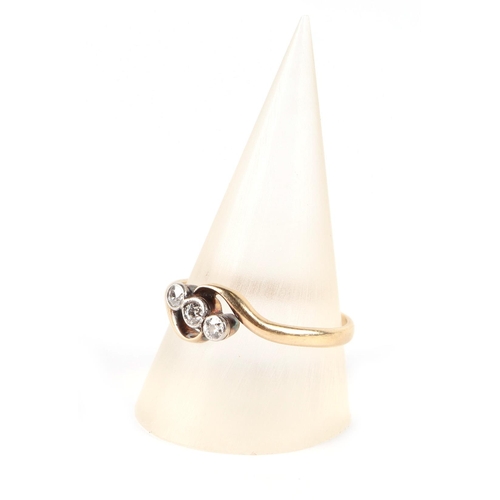 658 - An 18ct gold three-stone diamond ring, approx UK size R, 2.5g.