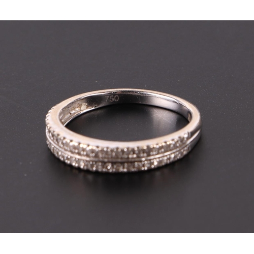 659 - An 18ct white gold ring set with two rows of small diamonds, approx UK size M, 2.4g.