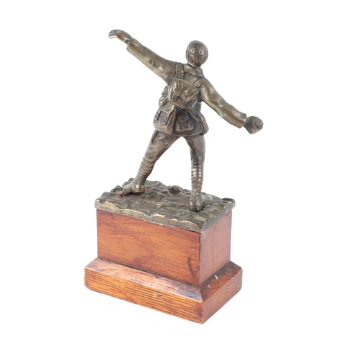 67 - A bronze sculpture by Sydney Wilkinson depicting a WWI soldier throwing a grenade, signed, 12cms hig... 