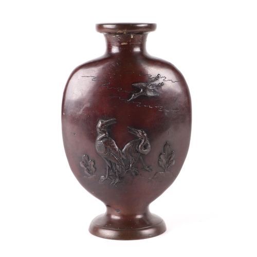 685 - A Japanese bronze vase decorated with cormorants and cranes, 25cms high.