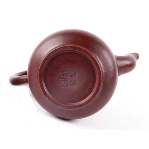 698 - A Chinese Yixing pottery teapot decorated with bamboo, four character mark to the underside, 16cm hi... 