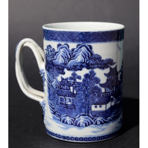 723 - A Chinese blue & white tankard with rope twist handle, decorated with a landscape scene with buildin... 