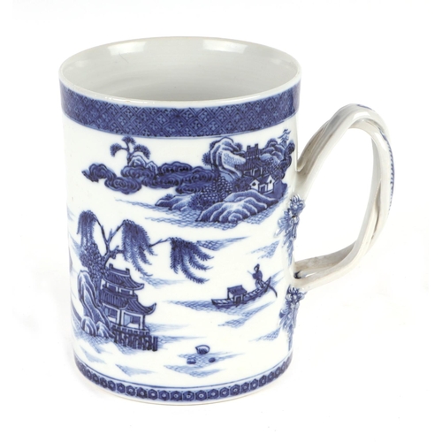 723 - A Chinese blue & white tankard with rope twist handle, decorated with a landscape scene with buildin... 