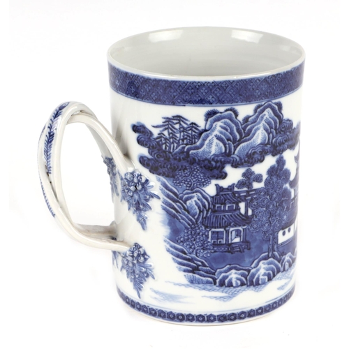 723 - A Chinese blue & white tankard with rope twist handle, decorated with a landscape scene with buildin... 