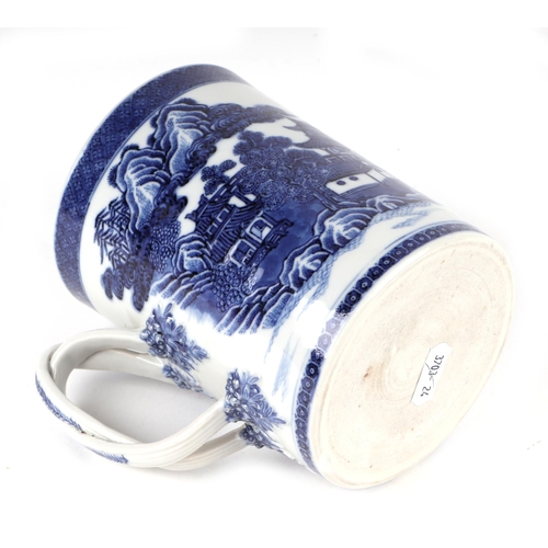 723 - A Chinese blue & white tankard with rope twist handle, decorated with a landscape scene with buildin... 