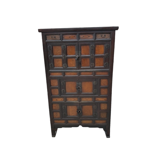 737 - A Korean floor standing cabinet with two small frieze drawers above three cupboards, 103cms wide.