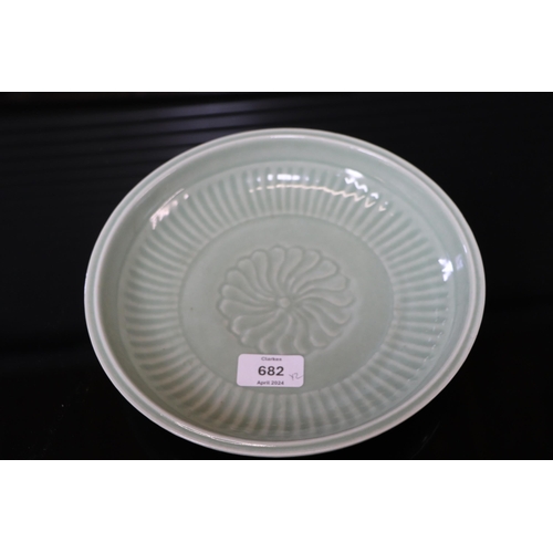 742 - A Chinese celadon glaze shallow dish, with six character blue marks to the underside, 26cm diameter,... 