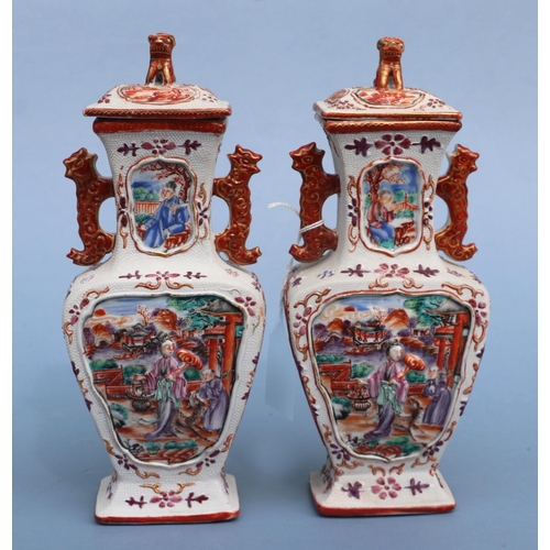 752 - A pair of Chinese Mandarin palette famille rose Export vases and covers moulded in relief with oppos... 