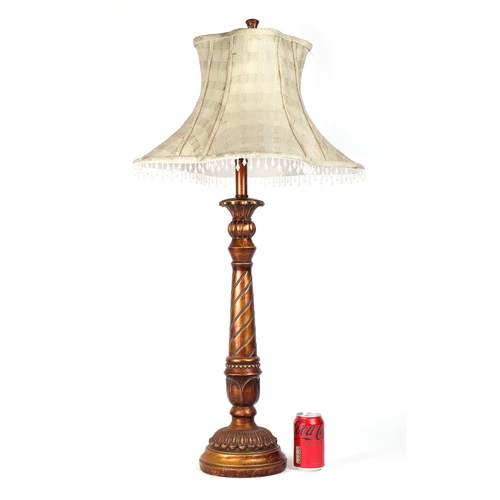 762 - A gilded table lamp, 90cms high including shade.