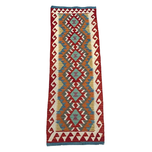 78 - A kilim runner with geometric repeating design on a multi coloured ground, 192 by 70cms.