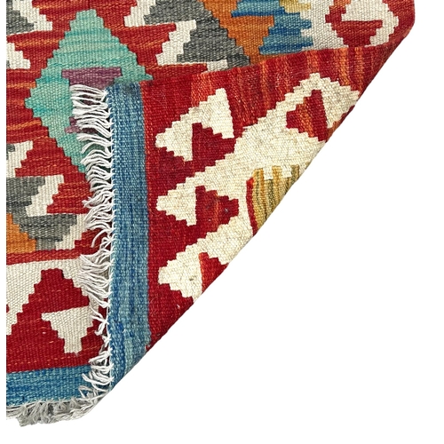 78 - A kilim runner with geometric repeating design on a multi coloured ground, 192 by 70cms.