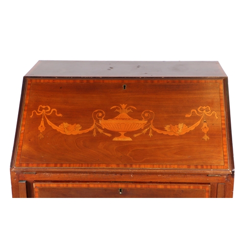 784 - An Edwardian inlaid mahogany bureau, the fall-flap enclosing a shelved interior above three long dra... 