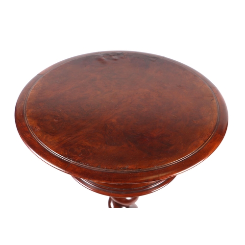 814 - A Victorian burr walnut teapoy, the circular top enclosing a fitted interior, on barleytwist column ... 