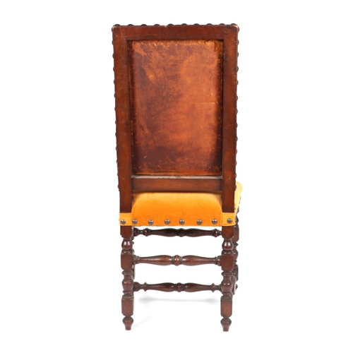 825 - A 17th century style occasional chair with tooled leather back and upholstered seat.