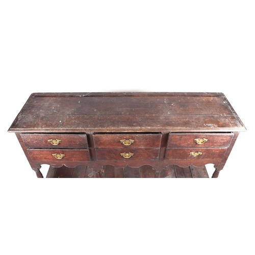 858 - A 19th century oak dresser base with an arrangement of six drawers above a shaped apron and pot boar... 