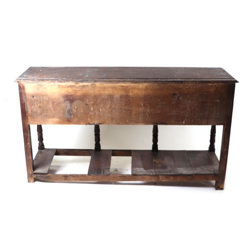 858 - A 19th century oak dresser base with an arrangement of six drawers above a shaped apron and pot boar... 