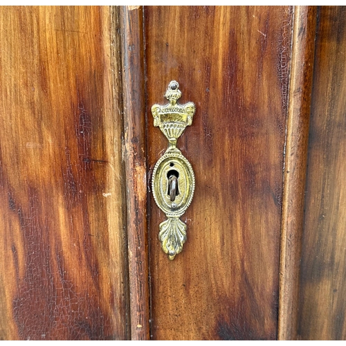 862 - A 19th century mahogany cabinet, the pair of field panelled doors enclosing a shelved interior, on b... 