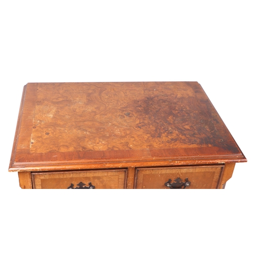 864 - A reproduction George III style burr walnut chest of small proportions, of two short and three long ... 