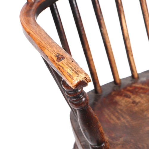 867 - A 19th century beech and elm Windsor chair with solid seat, ring turned front legs joined by an 'H' ... 