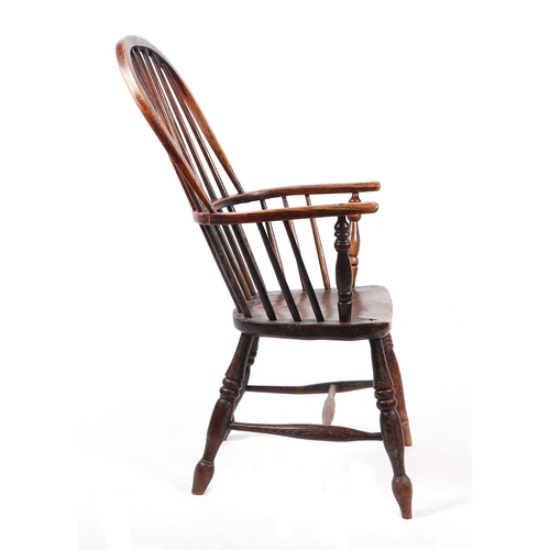 867 - A 19th century beech and elm Windsor chair with solid seat, ring turned front legs joined by an 'H' ... 