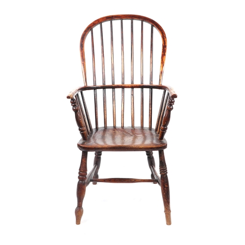 867 - A 19th century beech and elm Windsor chair with solid seat, ring turned front legs joined by an 'H' ... 