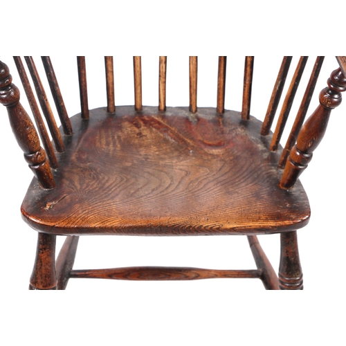 867 - A 19th century beech and elm Windsor chair with solid seat, ring turned front legs joined by an 'H' ... 