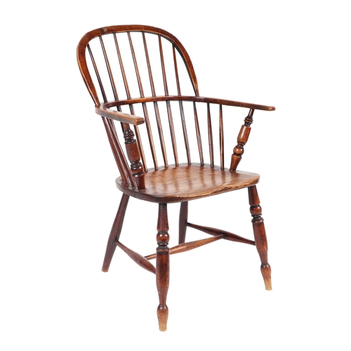 875 - A 19th century elm Windsor armchair on turned legs joined by an 'H' stretcher.