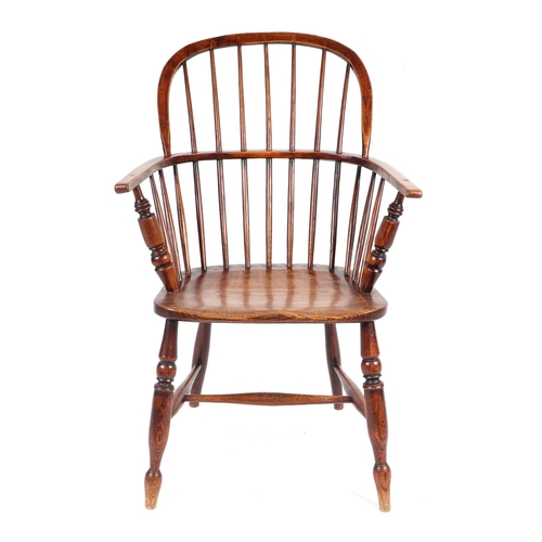 875 - A 19th century elm Windsor armchair on turned legs joined by an 'H' stretcher.