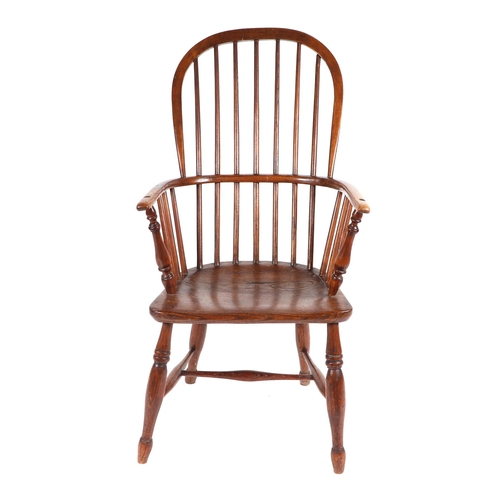 876 - A 19th century elm Windsor armchair on turned legs joined by an 'H' stretcher.