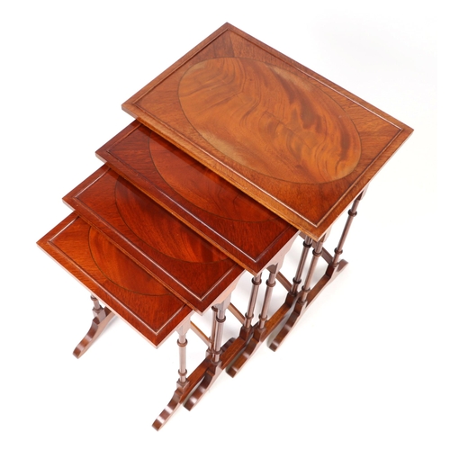 878 - A reproduction figured mahogany quartetto nest of tables, the largest 50cms wide.