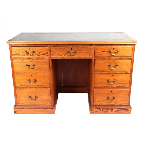 883 - A late 19th / early 20th century pitch pine pedestal desk, the rectangular top with inset green leat... 