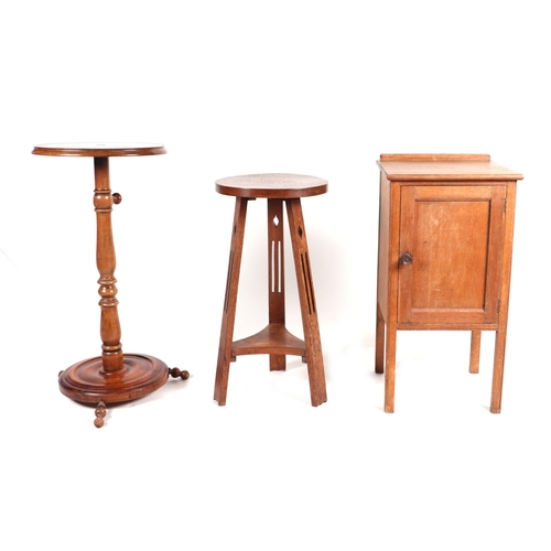 903 - An Arts & Crafts oak tripod table, the circular top on pierced supports joined by an under-tier, 34c... 