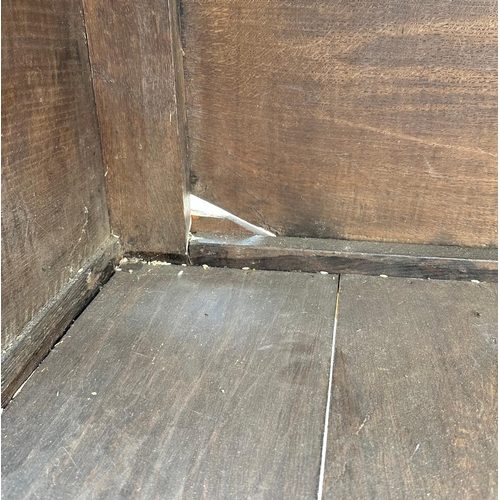 905 - An 18th / 19th century oak livery cupboard, the pair of panelled doors enclosing a shelved interior,... 