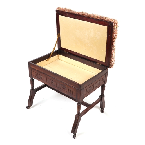 909 - An Edwardian carved walnut upholstered box piano stool, 60cms wide.