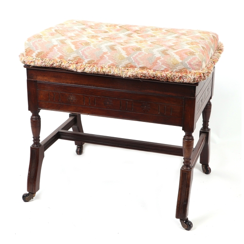 909 - An Edwardian carved walnut upholstered box piano stool, 60cms wide.