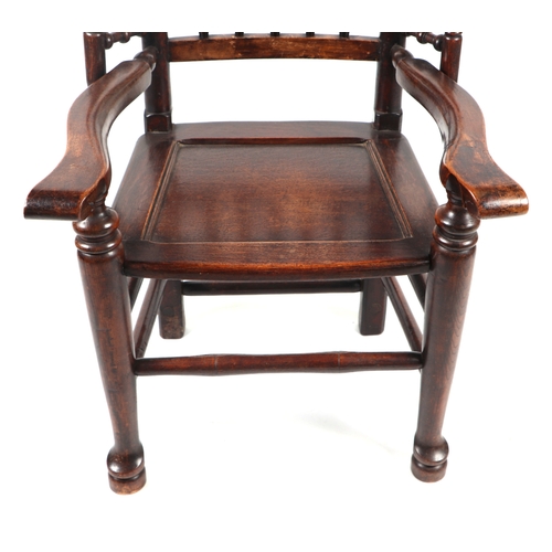 815 - A Lancashire spindle back armchair with solid seat, of small proportions.