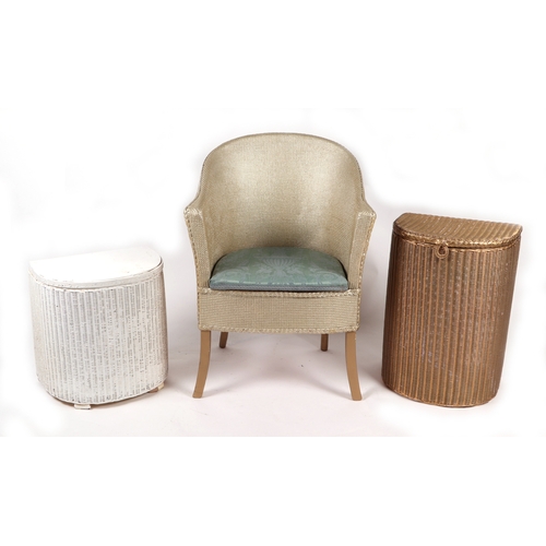 907 - A Lloyd Loom style open armchair; together with two similar laundry baskets (3).