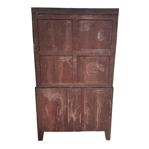 836 - An early 19th century mahogany linen press, the pair of panelled doors enclosing three linen slides ... 