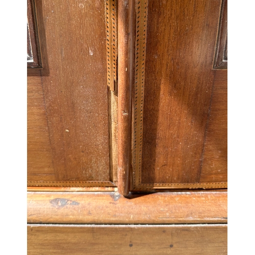 837 - An Edwardian inlaid mahogany wardrobe, 118cms wide.