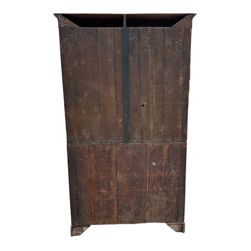 838 - A Georgian mahogany bureau bookcase, the pair of panelled doors enclosing a shelved interior above a... 