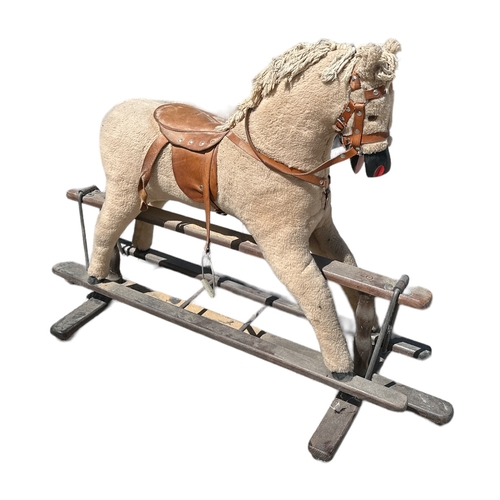 355 - A vintage safety rocking horse with leather saddle and bridle, approx 110cms wide.