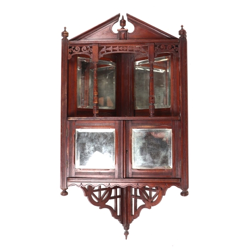 908 - An Edwardian walnut glazed corner cabinet, the shelf with bevel edged mirrors above mirrored cupboar... 