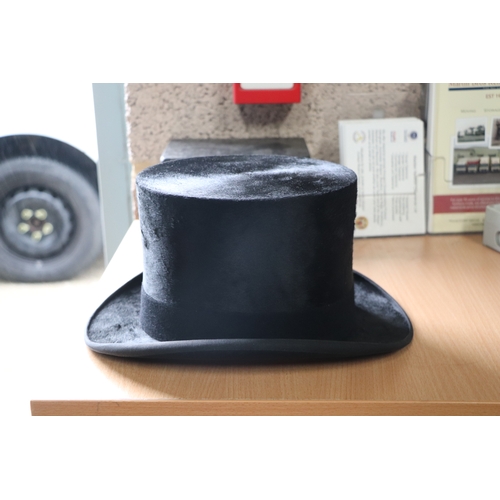 435 - A Dunn & Co. London moleskin top hat, approx 58.5cms diameter, in original cardboard box.